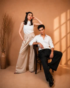 AWAISHU beige and black wide-leg trousers, studio campaign portrait